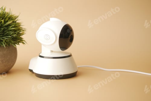 Preview: CCTV security camera operating on light orange background