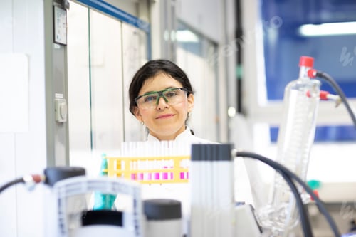 Preview: Confident scientist with a bright smile in a lab environment.
