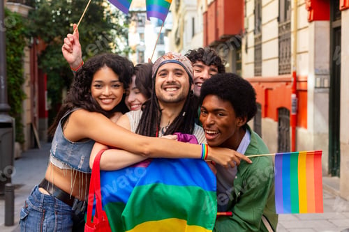 Preview: Happy multi ethnic friends celebrating lgbtq plus pride with rainbow flags