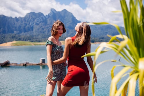Preview: two woman tourist friends in summer dresses on vacation travel around Thailand Khao Sok