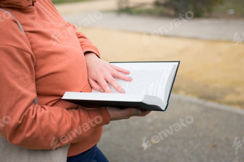 Preview: Close-up of a woman with a book in her hands