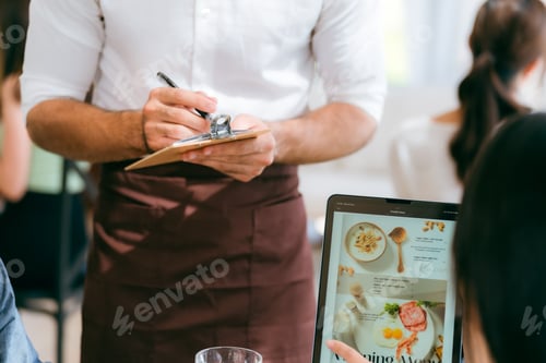 Preview: Enjoy Exceptional Service and Delicious Food at Our Eatery: Clients Savoring Meals and Drinks