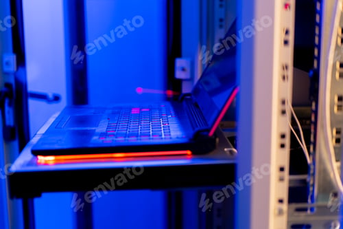 Preview: close up of laptop with code on screen hacker attack in server room in data center cyber security