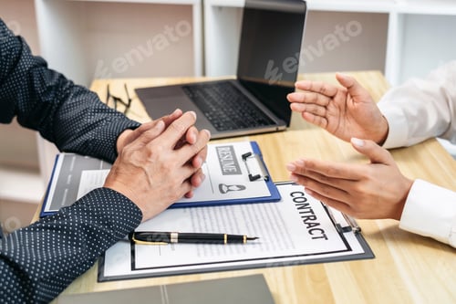 Preview: A man and a woman are sitting at a table with a resume in front of them