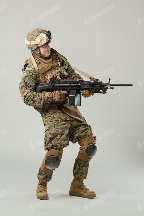 Preview: Soldier in military gear poses with rifle in studio setting during training session