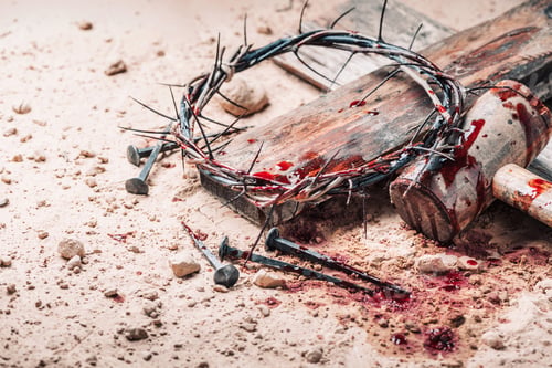 Preview: Old wooden cross, hammer, bloody nails and crown of thorns on ground. Banner. Copy space. Good