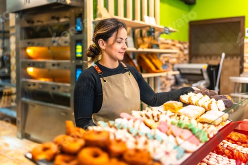 Preview: Woman selling bread and pastries in an artisan bakery