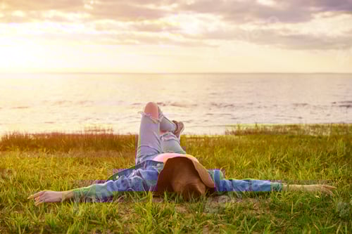 Preview: happy young woman lies on the bay