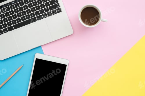 Preview: Top view office desk with laptop, phone, pencil, notebook and coffee cup.