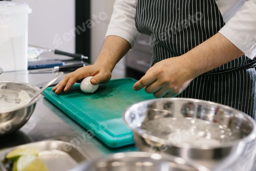 Preview: Close up. A male cook is cleaning boiled eggs in the kitchen of a restaurant.