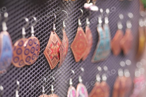 Preview: Colorful earrings displayed at a craft market in autumn