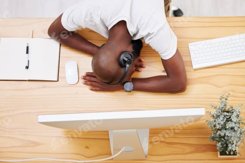 Preview: Being a human being is tiring. Shot of a young businessman taking a nap at his desk.