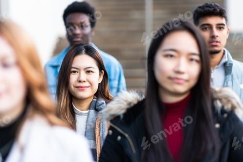 Preview: Multiracial crowd of people in the city commuting and walking on pavement