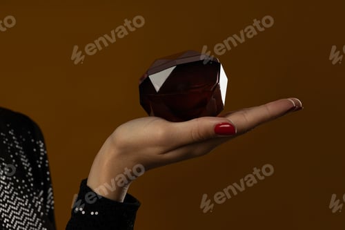 Preview: Beautiful bottle with perfume in hand close-up