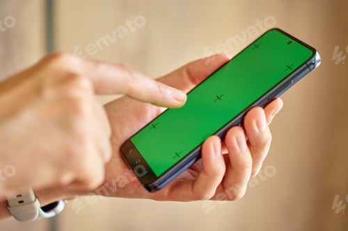 Preview: Hands using smartphone with green screen