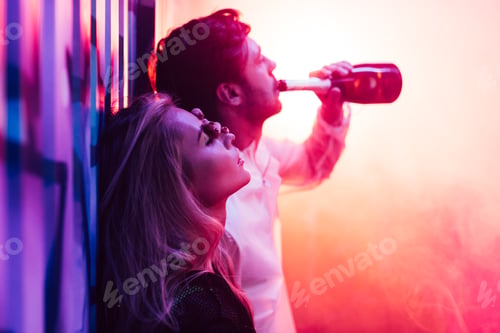 Preview: attractive and blonde woman with closed eyes and handsome man drinking champagne