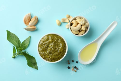 Preview: Bowl of Pesto sauce and ingredients on blue background