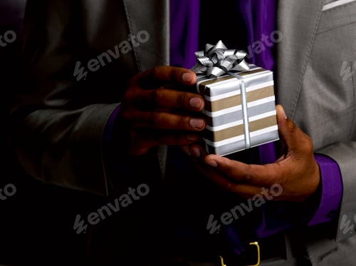 Preview: Business man holding gift