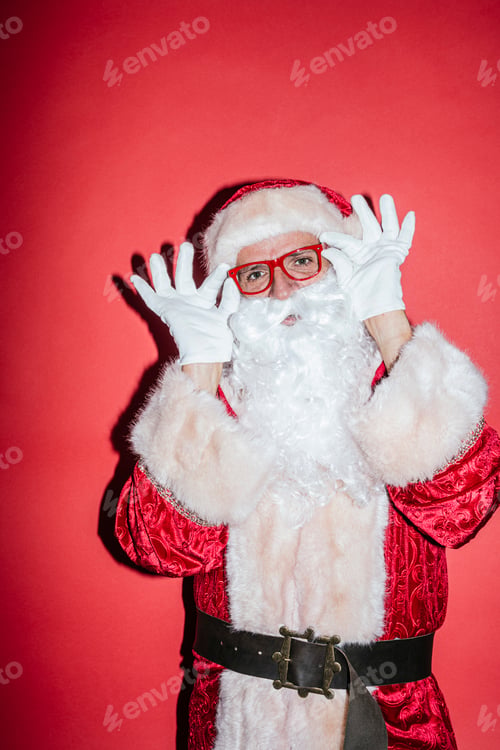 Preview: Man dressed as Santa Claus gesturing with funny glasses
