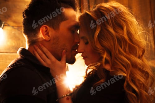 Preview: Blured couple in love hugging against the background of glowing lights. Studio portrait