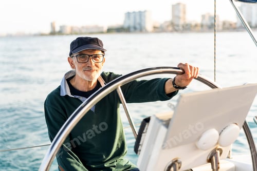 Preview: Experienced sailor steering yacht on calm waters