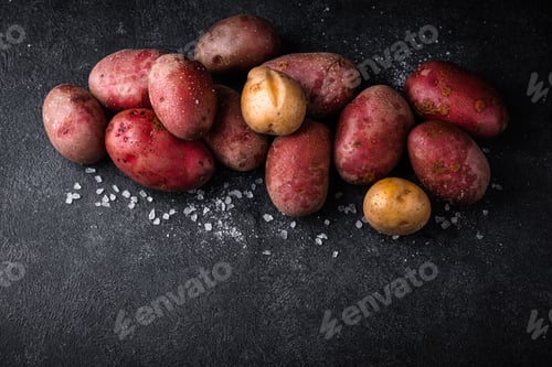 Preview: Raw uncooked potato on dark table