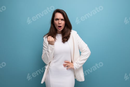 Preview: Furious Woman Clenched Fist Against Blue Background