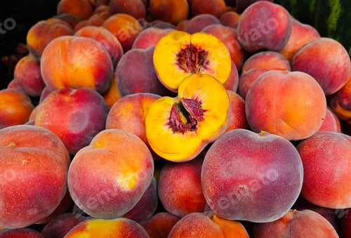 Preview: Ripe juicy peaches close-up at a market, natural fruit background