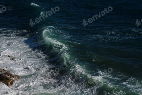 Preview: Ocean wave background breaking sea water rocky shore