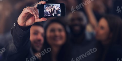 Preview: Cropped shot of a group of young friends taking selfies while dancing together in a nightclub