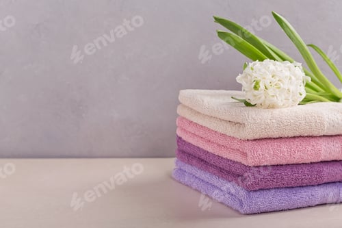 Preview: Stack of Colorful Bath Towels with Hyacinth Flower