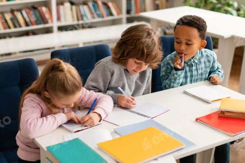 Preview: African american elementary schoolboy peeking on classmate's answer during test in primary school