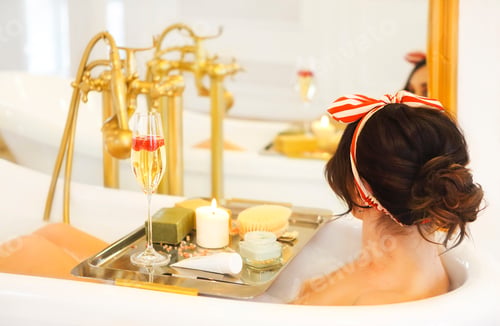 Preview: Attractive girl relaxing in bath on light background