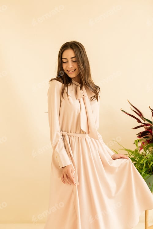 Preview: Beautiful young elegant woman brunette in long dress high heels. Date or party