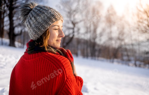 Preview: Beautiful winter landscape with woman walking through snowy field