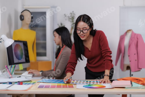 Preview: Fashion designers choosing colors for new clothes collection in design studio