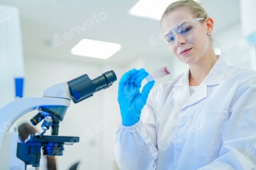 Preview: A confident female histologist inspects a stained tissue slide after processing,