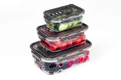 Preview: Closeup of plastic containers filled with tomatoes, cucumbers, blackberries, and strawberries