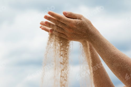 Preview: Female hands with sand gracefully flowing through the fingers, symbolizing different concepts