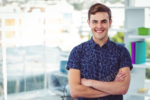 Preview: Man standing with arms crossed at office desk by window showing urban skyline, shelving unit