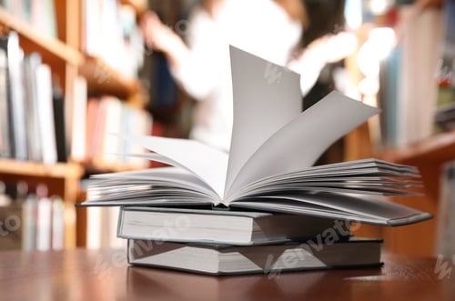 Preview: Stack of books on table in library