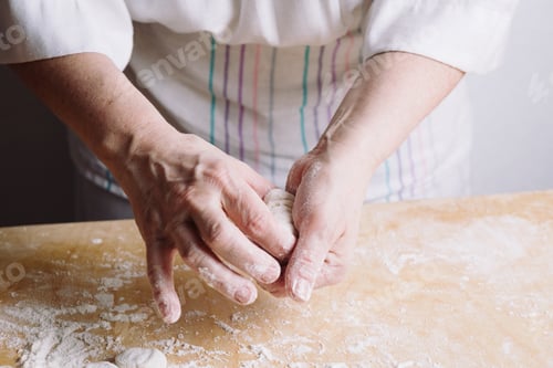 Preview: Two hands making meat dumplings.