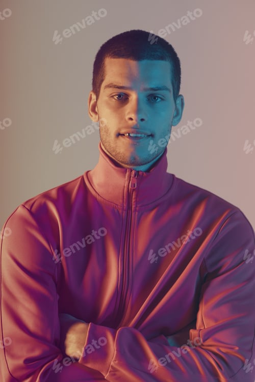 Preview: Studio close-up portrait of attractive male model. Color flash studio light
