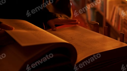Preview: Man reading large mysterious book. Stock footage. Close-up of mysterious man reading ancient