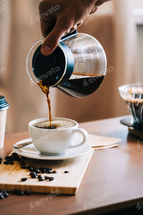 Preview: Man pouring coffee in a cup, alternative coffee brewing method, using pour over dripper