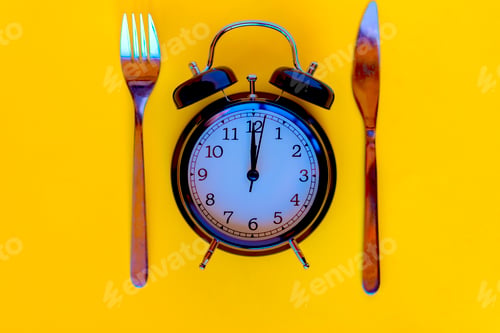 Preview: Time concept of dieting. Black alarm clock.