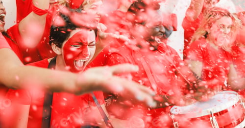 Preview: Red sport fans screaming while supporting their team at stadium
