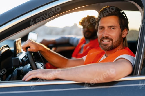 Preview: Construction workers driving car wearing safety vests