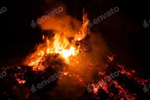 Preview: Big pile of ashes burning in the night