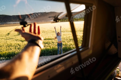 Preview: The happy girl has fun on a wonderful camping day. Van life concept.